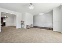 Spacious living room with neutral carpet, wainscoting and open floor plan to dining area at 615 Ceremony Way, Acworth, GA 30102