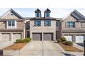 Attractive brick townhome with a two-car garage and a well-manicured lawn and driveway at 2069 Brightleaf Way # 123, Marietta, GA 30060