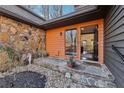 Inviting entrance featuring a stone facade and decorative landscaping, leading to an open doorway at 320 Spyglass Blf, Alpharetta, GA 30022