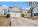 Side view of a well-maintained home with a two-car garage and a concrete driveway at 3226 Wellington Sw Walk, Atlanta, GA 30331