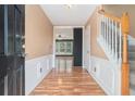 Inviting foyer with hardwood floors, staircase, and views into the adjacent living area, creating an open and welcoming entrance at 3226 Wellington Sw Walk, Atlanta, GA 30331