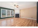 Spacious living room featuring hardwood floors, a cozy fireplace, and large windows offering ample natural light at 3226 Wellington Sw Walk, Atlanta, GA 30331