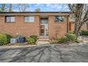 Brick condo with covered entry, landscaping, and paved driveway at 2570 Bradford Ne Sq, Atlanta, GA 30345