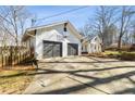 Exterior angle of home with spacious two-car garage and a basketball hoop at 915 Homer Rd, Woodstock, GA 30188