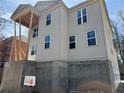 New construction home with gray siding and modern windows at 2585 Governors Walk Blvd, Snellville, GA 30078