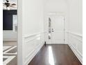 Bright foyer with dark hardwood floors, white walls with paneling, and a view into other rooms at 334 Cherokee Station Cir, Woodstock, GA 30188