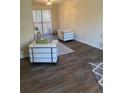 Living room featuring hardwood floors, natural light from the sliding doors, and modern seating arrangement at 6950 Oakhill Se Cir, Austell, GA 30168