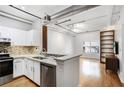 Modern kitchen with white cabinets, stainless steel appliances, and an eat-in bar area at 800 Peachtree Ne St # 1320, Atlanta, GA 30308