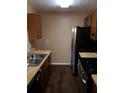 A kitchen featuring stainless steel appliances and dark wood cabinets at 2303 Pine Tree Trl, Atlanta, GA 30349