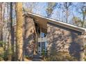 Striking brick home with a modern design and large front windows at 3897 Allsborough Dr, Tucker, GA 30084