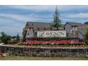 The Avignon: An Ashton Woods Community entrance sign with a beautiful stone facade and colorful flower beds at 691 Calvet Way, Cumming, GA 30041