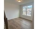 A versatile flex space with hardwood floors, large windows offering natural light and views of the neighborhood at 691 Calvet Way, Cumming, GA 30041