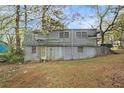 View of the back of the home showcasing the yard, two stories, and basement entrance at 2057 Akron Se Dr, Atlanta, GA 30315