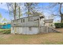A look at the home's two-story rear featuring a basement level and backyard at 2057 Akron Se Dr, Atlanta, GA 30315