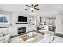 Open-concept living room featuring a fireplace, large windows, and seamless flow into the kitchen at 2000 Cortland Rd, Milton, GA 30009