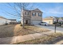 Inviting two-story home with brick exterior and two-car garage, complemented by a well-maintained yard at 2126 Sawgrass Dr, Hampton, GA 30228
