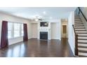 Bright living room featuring hardwood floors, fireplace, and large windows for natural light at 464 Eager Ct, Marietta, GA 30064