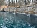 Beautiful pool featuring a stone waterfall wall, perfect for relaxing and enjoying the outdoors at 464 Eager Ct, Marietta, GA 30064