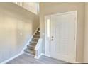 Bright foyer features staircase, high ceilings, and light wood-look floors at 5863 Trent Walk Dr, Lithonia, GA 30038
