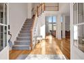 Grand foyer showcasing hardwood floors, staircase, and natural light at 551 Lees Mill Rd, Fayetteville, GA 30214