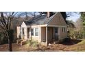 Traditional single-Gathering home with covered porch and mature trees at 1497 Clermont Ct, Atlanta, GA 30344