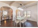 Bright dining room featuring hardwood floors, white table with chairs, and elegant chandelier at 5809 Savannah River, Atlanta, GA 30349