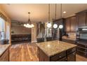 Modern kitchen with granite island, stainless steel appliances, dark cabinetry, and hardwood floors at 5809 Savannah River, Atlanta, GA 30349