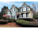 Lovely exterior view of a two-story home, showcasing the welcoming front porch at 2460 Millwater Crossing Xing, Dacula, GA 30019