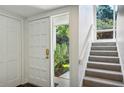 Bright entryway with white walls and a carpeted staircase at 2106 Clairmeade Valley Ne Rd, Atlanta, GA 30329