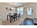 Elegant dining room with dark wood furniture, carpet and natural light from the window at 3158 Onamia Rd, Duluth, GA 30096