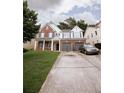 Charming two-story home featuring brick accents, white siding, a well-manicured lawn, and an attached two-car garage at 4617 Stone Lane, Stone Mountain, GA 30083