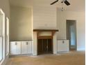 Living room fireplace featuring a wooden mantle and built-in cabinets for stylish storage at 554 Presley Farm Pkwy, Rockmart, GA 30153