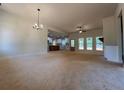 Spacious living room featuring modern lighting, abundant natural light, and a view of the open kitchen at 554 Presley Farm Pkwy, Rockmart, GA 30153