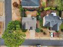 Aerial view of a home with a well manicured lawn and mature trees, surrounded by a quiet neighborhood at 1548 Pinebreeze Dr, Marietta, GA 30062