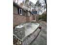 Back patio with brick accents and swing seating at 2720 Sandy Creek Cir, Loganville, GA 30052