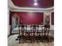 Formal dining room features a large table with decorative chairs and an elegant china cabinet at 1755 Riverpark Dr, Dacula, GA 30019