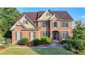Stately brick residence with manicured lawn and decorative landscaping at 1755 Riverpark Dr, Dacula, GA 30019