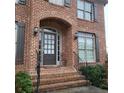 Inviting front entrance with brick steps, elegant black railings, and a classic multi-paneled door at 1755 Riverpark Dr, Dacula, GA 30019