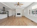 Inviting living room featuring a modern fireplace, gleaming hardwood floors, and abundant natural light from large windows at 1926 Camellia Dr, Decatur, GA 30032