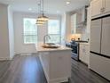 Modern kitchen with white cabinetry, stainless steel appliances, and a large island perfect for entertaining at 4320 Sims Park Overlook, Suwanee, GA 30024