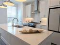 Bright kitchen featuring stainless steel appliances and a spacious island with a quartz countertop at 4320 Sims Park Overlook, Suwanee, GA 30024