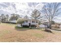 Split-level home featuring a well-maintained lawn and mature trees at 3025 Creel Rd, Atlanta, GA 30349