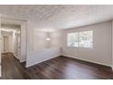 Open-concept living area with new dark hardwood flooring and neutral walls at 3025 Creel Rd, Atlanta, GA 30349