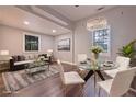 Inviting dining area with elegant chandelier, glass table, and comfortable seating at 7880 Rivertown Rd, Atlanta, GA 30213