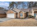 Inviting brick home featuring a two-car garage and manicured landscaping at 4203 Jordans Bank, Union City, GA 30291