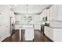 Bright kitchen featuring white cabinets, stainless steel appliances, and a center island at 549 Henry Dr, Marietta, GA 30064