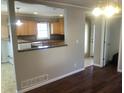 Dining room view showing granite counters, wooden cabinets, and a tiled floor entrance at 3387 Forest Hill Rd, Powder Springs, GA 30127