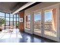 Bright living room with large windows, exposed brick, and balcony access offering city views at 395 Central Park Ne Pl # 420, Atlanta, GA 30312