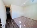 Neutral walls with luxury plank flooring meet carpet in this bright, naturally lit living space at 7722 Sudbury Cir, Covington, GA 30014