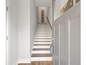 Entryway view of wooden staircase featuring white risers and wood-look flooring at 2030 Main Nw St # 205, Atlanta, GA 30318